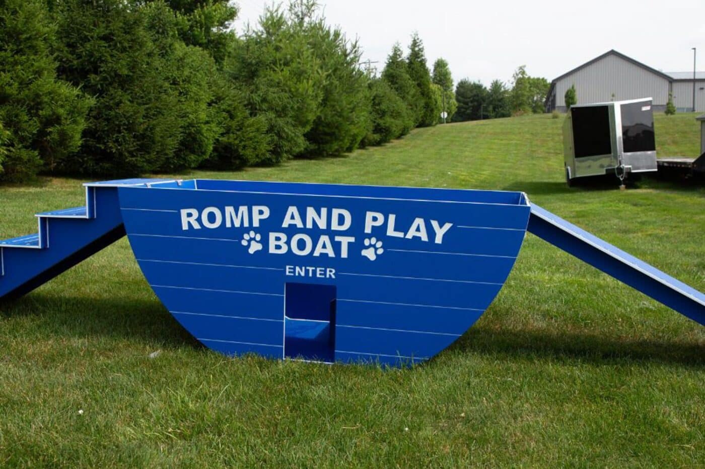 Blue Romp and Play Boat in backyard